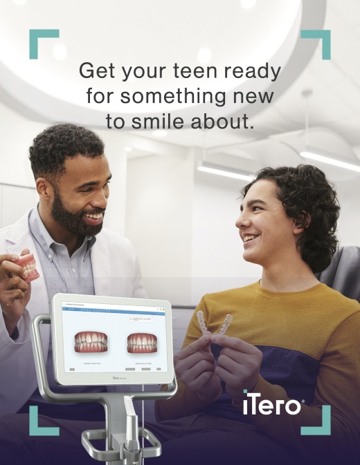Get your teen ready for something new to smile about, doctor photographed showing a model of straight teeth to a teen patient.